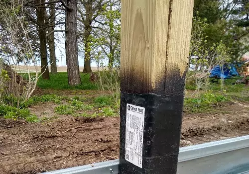 A column with a grade board affixed to it, part of Anthem Built's Post-Frame Building Supplies in Illinois
