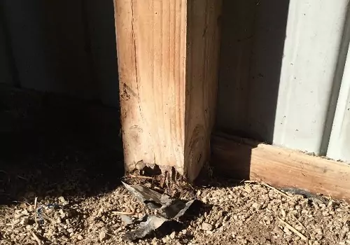 A rotting wood column in need of repair in Illinois