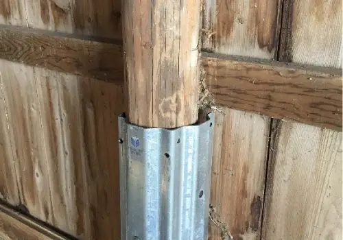 A column with a repair sleeve after Pole Barn Repair in Springfield IL