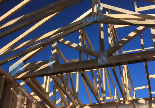 Connections on trusses and columns of a post-frame structure being built