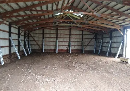 The interior of a post-frame structure before post repair instead of Pole Barn Post Replacement in Peoria IL