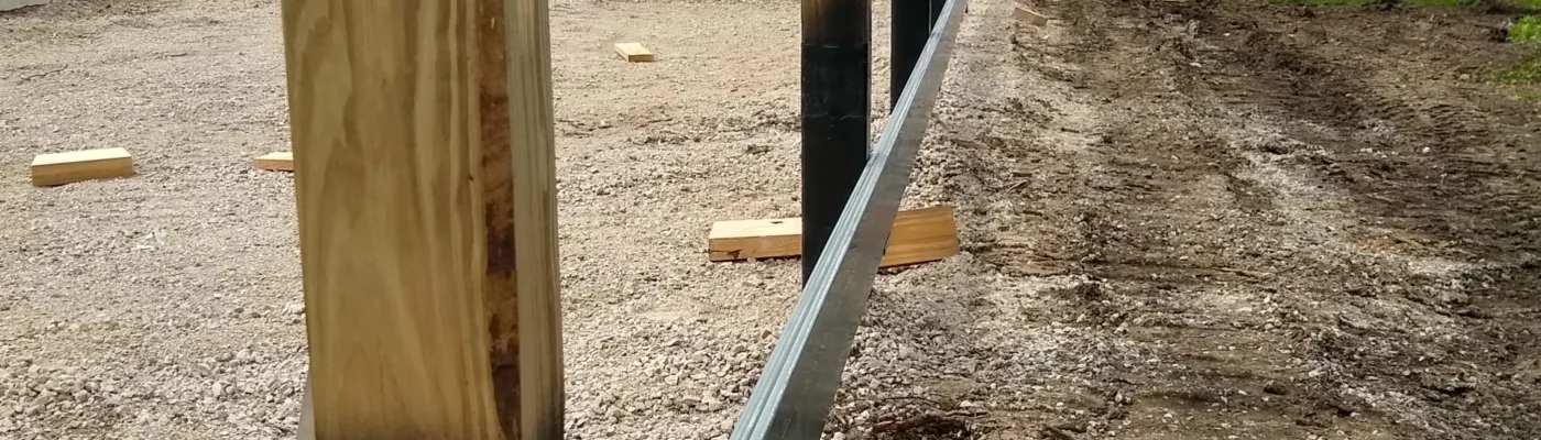 Contractors using column repair systems on a post-frame building in Iowa